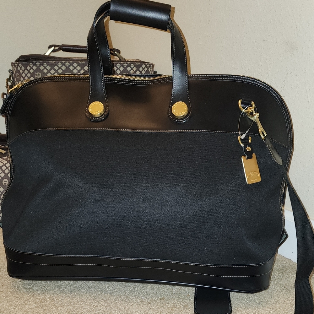 Dooney and Bourke Elegant Black Leather Weekender Bag, unisex. NWOT